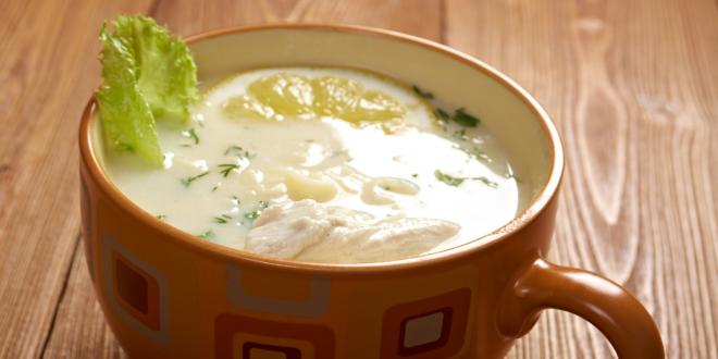 A mug of avgolemono soup with garnish