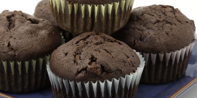 A plate of chocolate cupcakes in paper cups
