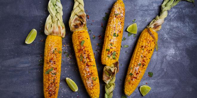 ears of grilled corn with lime, paprika, and cheese